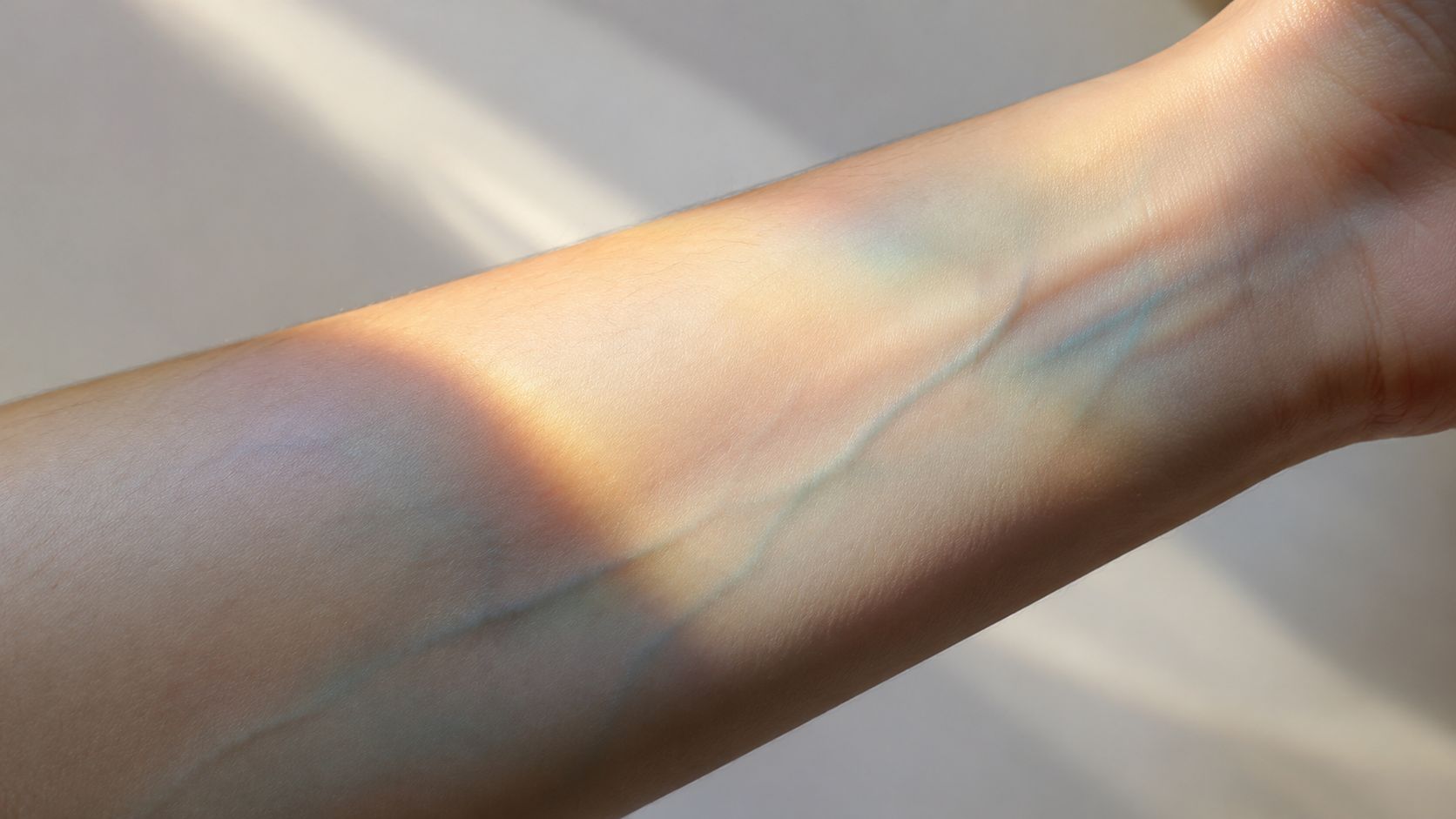 Close-up of a person's inner forearm showing visible veins under soft light for skin tone analysis