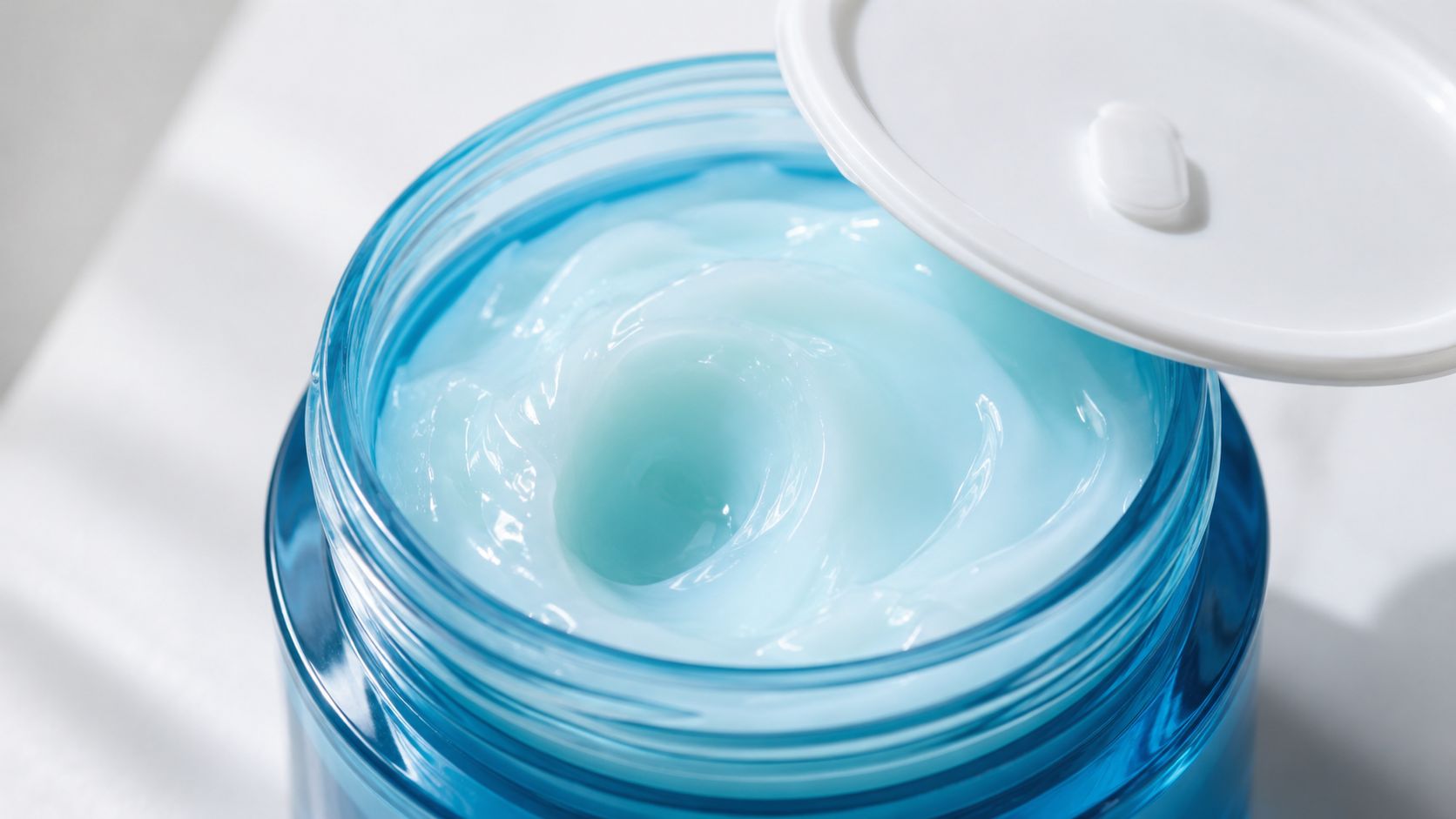 An open jar of Neutrogena Hydro Boost water gel showing the light blue moisturizing cream texture.