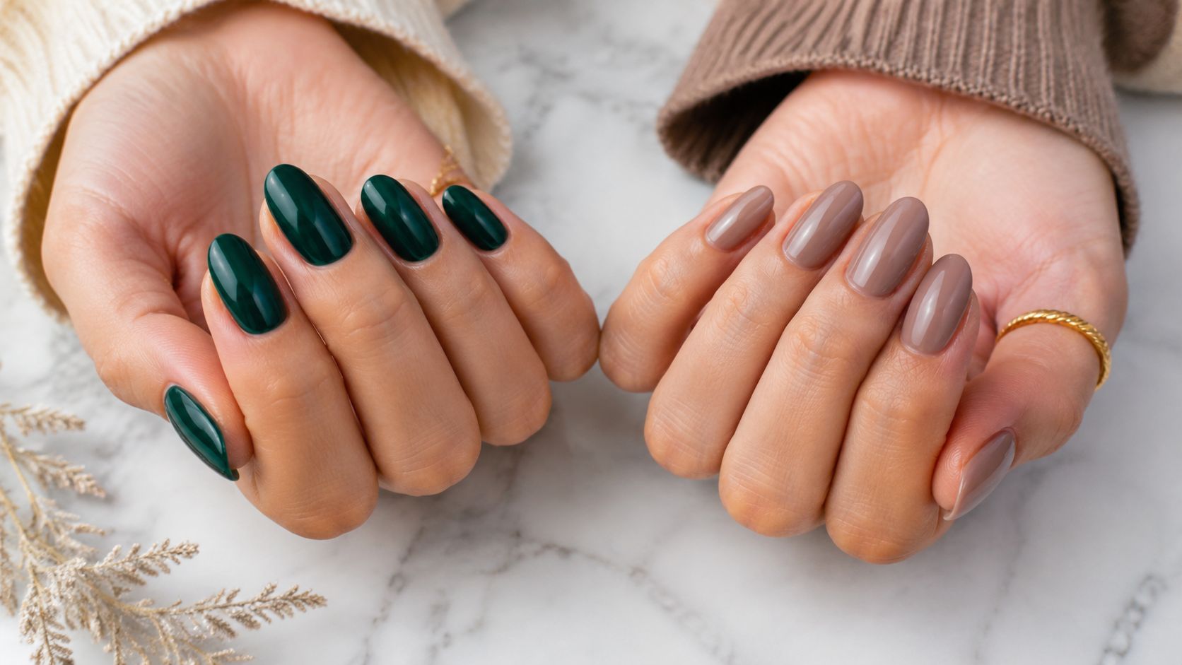 Two hands showcasing elegant winter nail colors in dark forest green and soft nude shades.