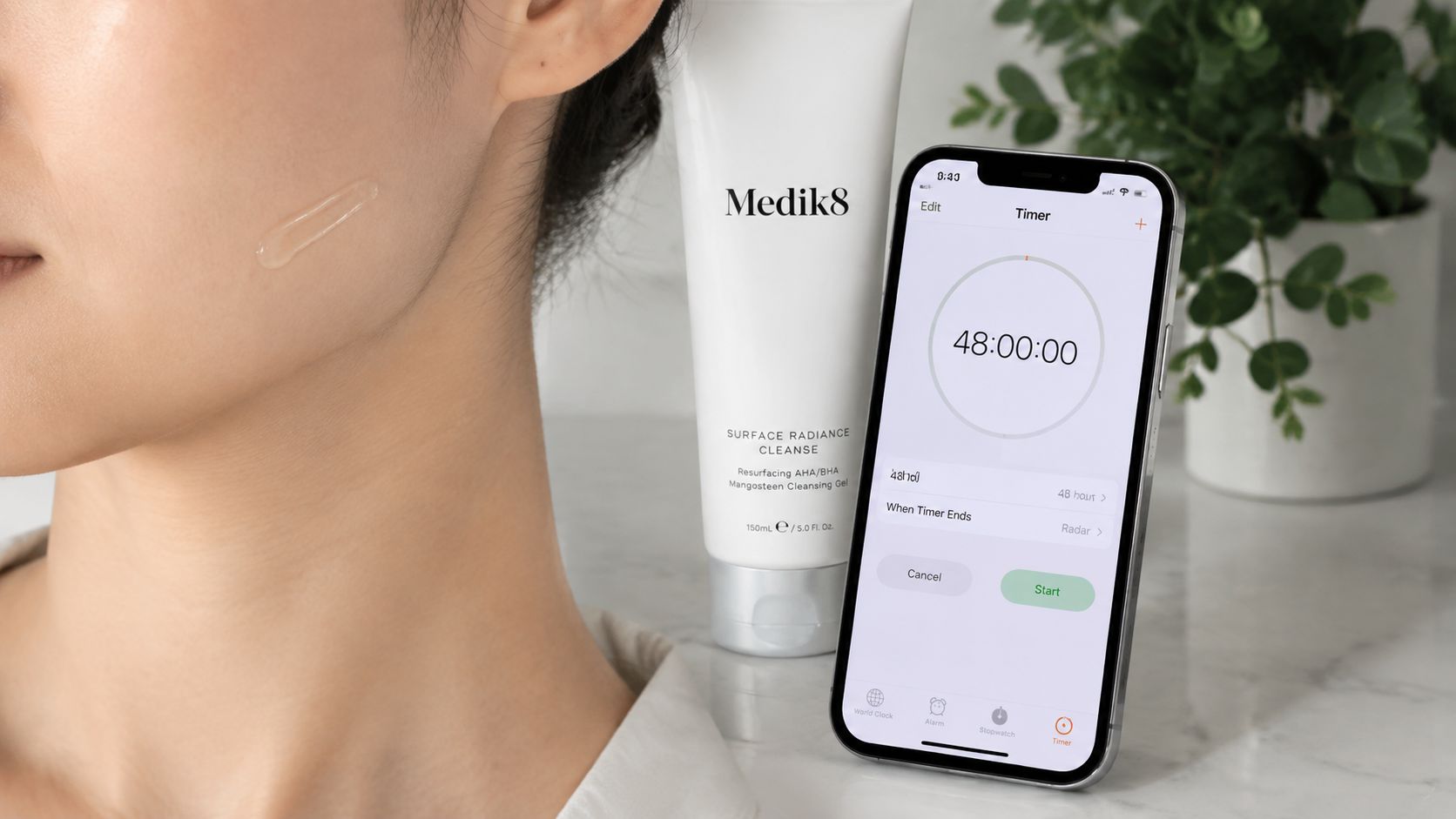 A Medik8 Surface Radiance Cleanse tube next to a smartphone showing a 48-hour timer on a marble surface.