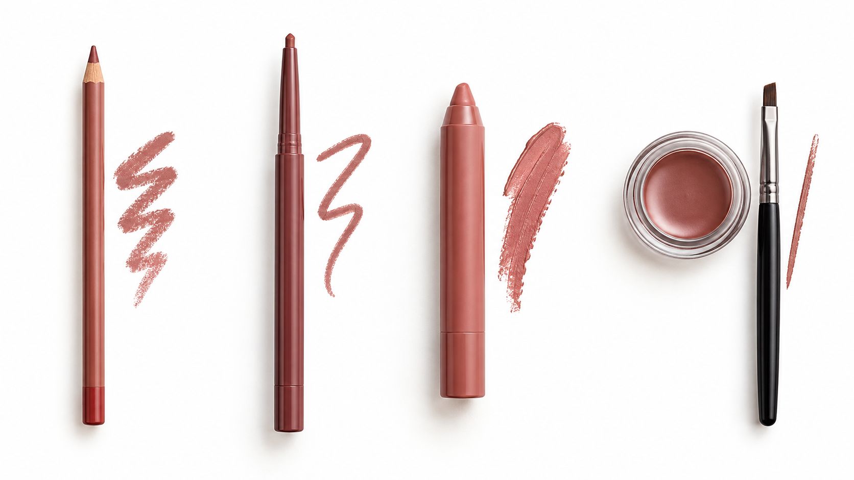 A top-down view of various rose-toned lip products including pencils, a crayon, a pot, and a brush.