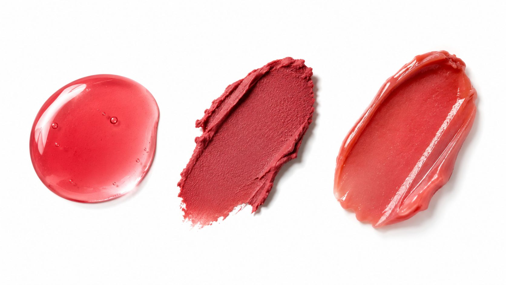 Three different swatches of red lip product on a white background showing various textures and finishes.