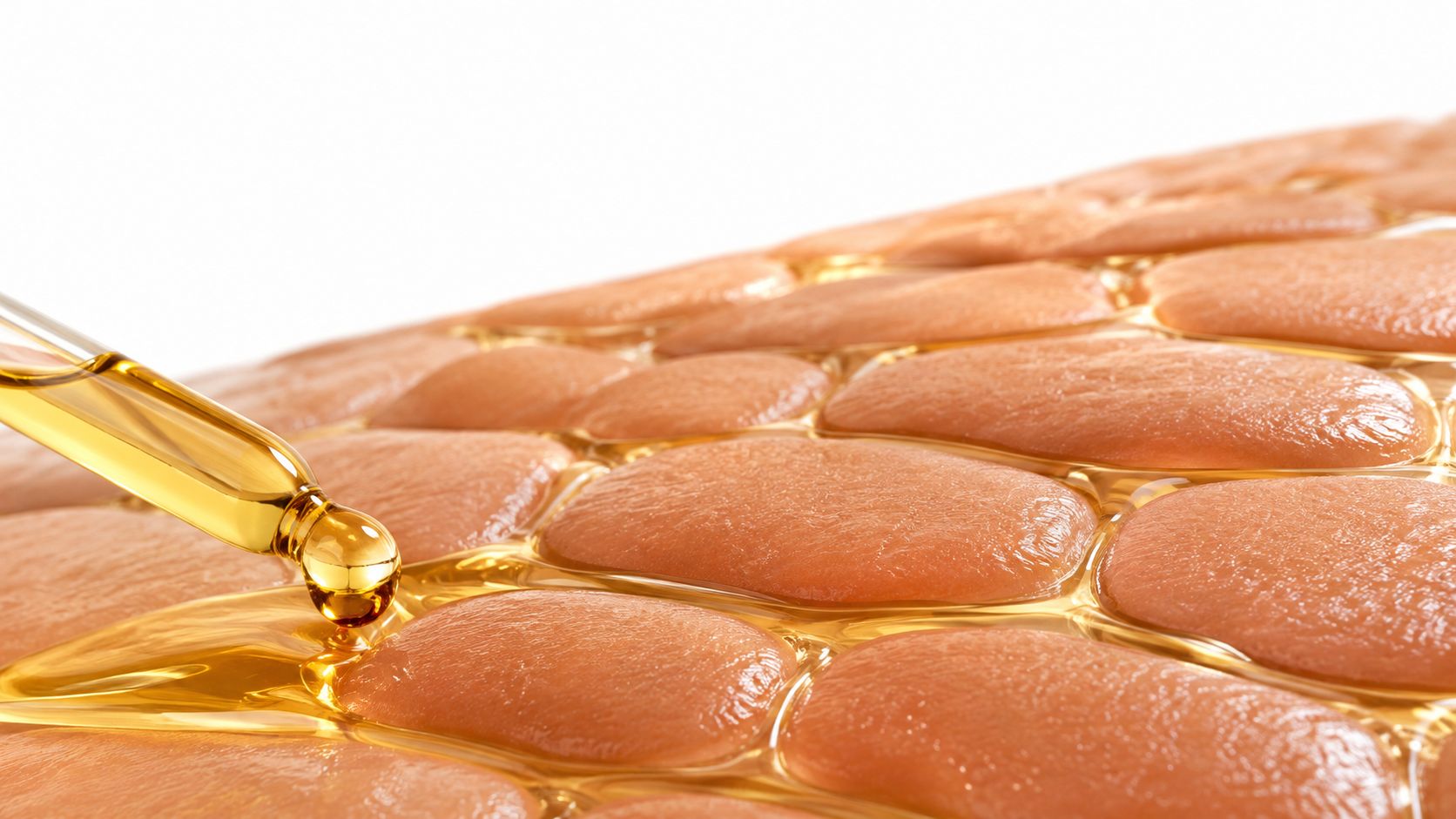 A close-up of a glass dropper applying golden face oil onto a smooth, textured skin surface.